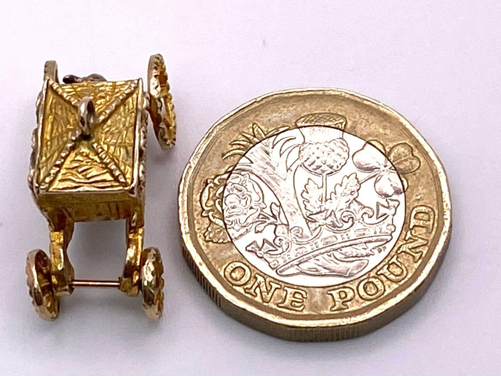 A 9K Yellow Gold Royal Carriage Charm with Moving Wheels. Approximately 24mm wide, 4.2g weight. - Image 3 of 4