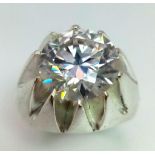 A Dazzling 6.65ct White Moissanite Ring. Set in 925 Silver. Size T. 15.35g total weight. Comes