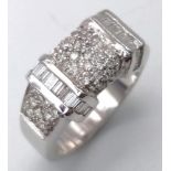 A Sophisticated 18K White Gold Mixed Diamond Ring. Pave set diamonds in-between two bars filled with