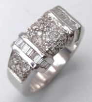 A Sophisticated 18K White Gold Mixed Diamond Ring. Pave set diamonds in-between two bars filled with