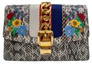 Gucci Snakeskin Leather, Floral Embodied Bag. This versatile bag can be carried as a clutch or a