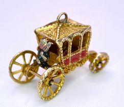 A 9K Yellow Gold Royal Carriage Charm with Moving Wheels. Approximately 24mm wide, 4.2g weight.