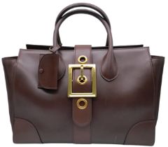 A Gucci Black Lady Buckle Tote Bag. Leather exterior with two rolled leather handles, gold toned