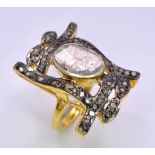 A spectacular antique silver and gold ring with a large natural, uncut diamond (3 carats appr.)