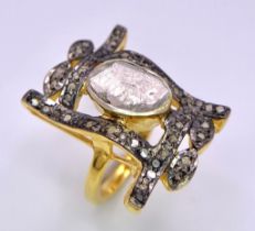 A spectacular antique silver and gold ring with a large natural, uncut diamond (3 carats appr.)