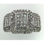 An Art Deco Style 18K White Gold and Diamond Ring. A belt-buckle design of round and princess cut