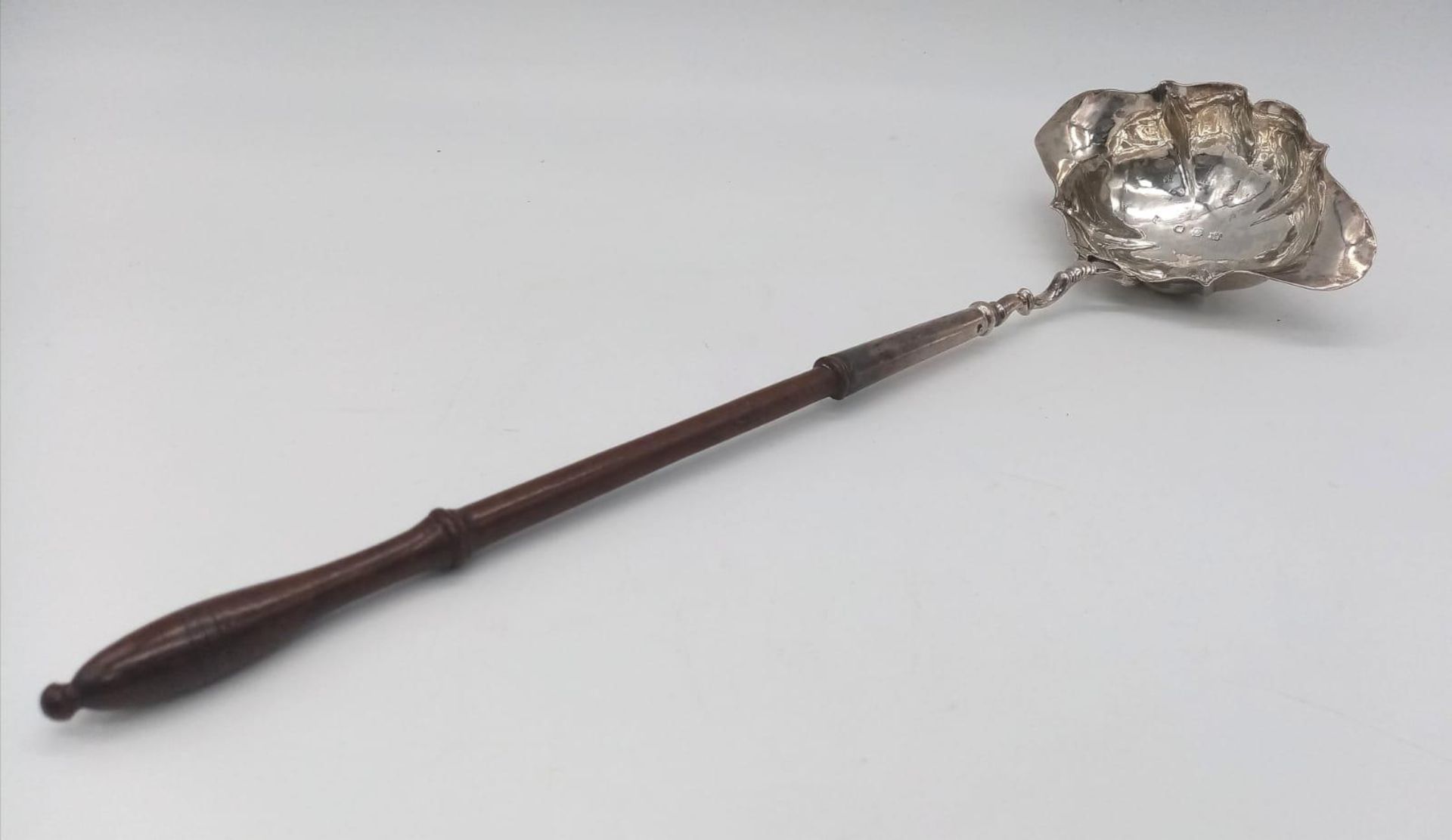A GEORGIAN SILVER PUNCH LADLE CIRCA 1810 AND MADE IN LONDON , WEIGHING 66.8gms and 30cms IN LENGTH ,