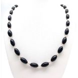A Onyx, Pearl & Gold Beaded Necklace with a 9kt Yellow Gold Clasp. Measuring 58cm in length, this