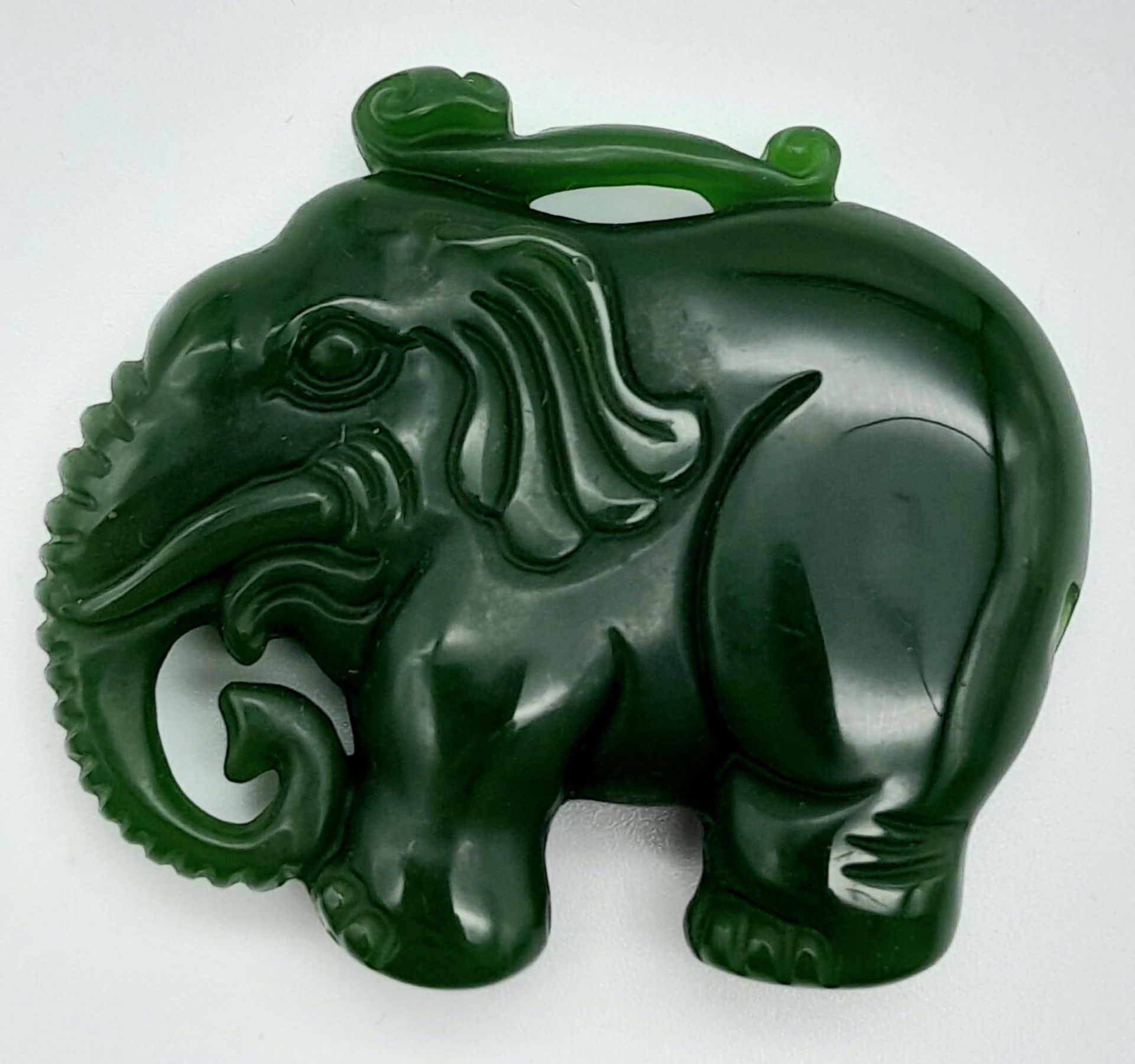 A Green Jade Chinese Hand-Carved Elephant Pendant. 5cm x 4cm.