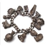 A very unique vintage silver bracelet with multiple charms such as Egyptian Pharaoh, classic auto