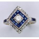 A Platinum, Diamond and Sapphire Ring. Central round cut diamond with a square cut sapphire and