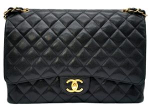 Chanel The Large Classic Handbag exudes timeless elegance with its grained calfskin and gold-tone