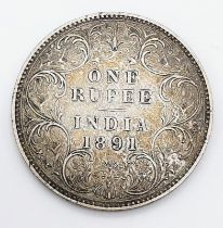 An 1891 Queen Victoria One Rupee Silver Coin.