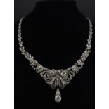 A Majestic Art Deco 7ctw Diamond (approx) Platinum Lavaliere Necklace. Scrolled and foliate