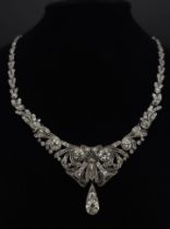 A Majestic Art Deco 7ctw Diamond (approx) Platinum Lavaliere Necklace. Scrolled and foliate