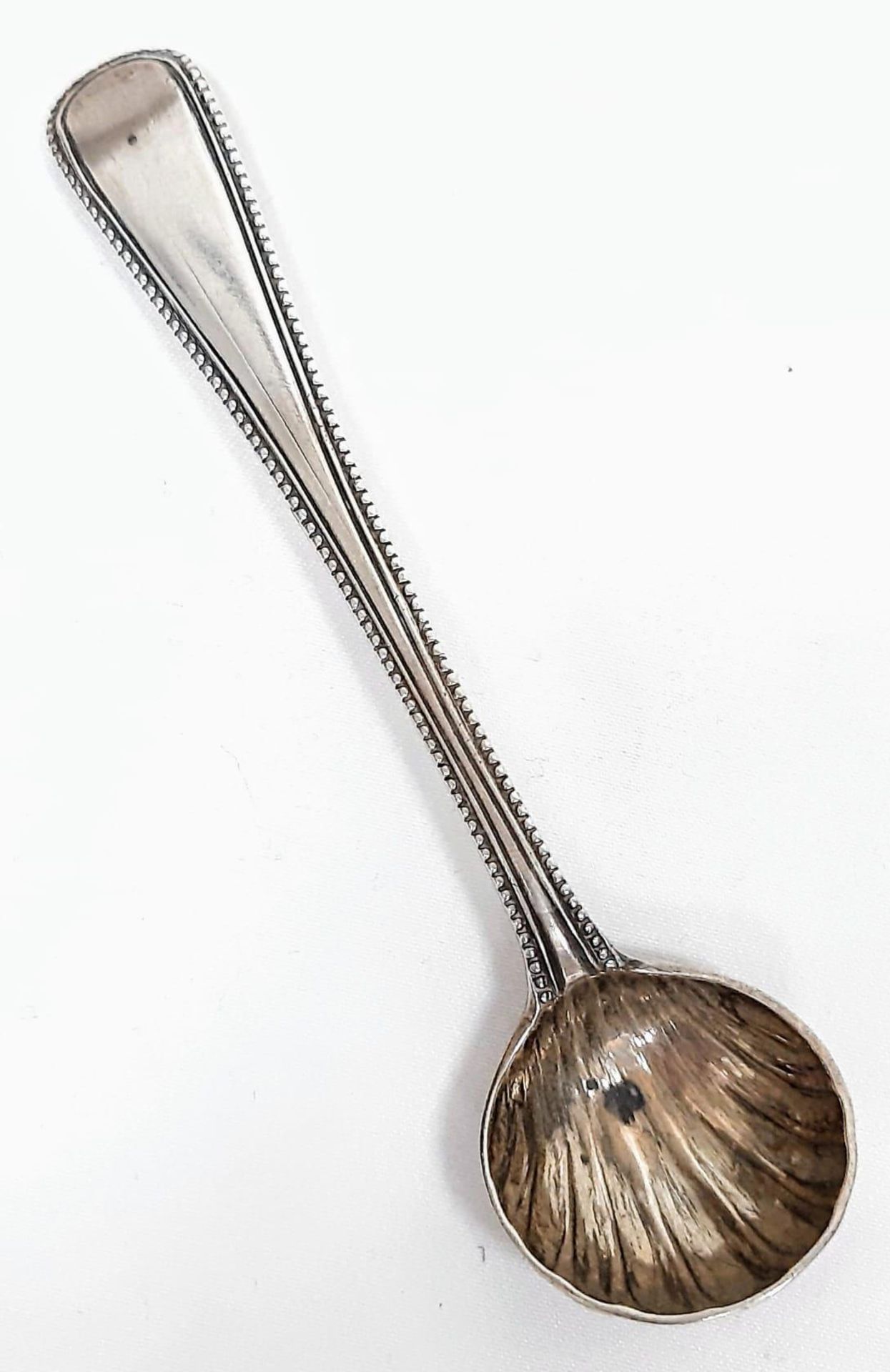 An Antique Victorian sterling silver sugar spoon with shell decoration. Full London hallmarks, 1864.