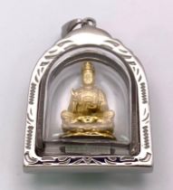 Metal framed Charm/Pendant with a Statue of Buddha enclosed. Measures 4cm x 3cm.