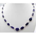 A stylish Blue Sapphire long chain necklace, set in Sterling Silver. This classic necklace