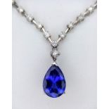 An 18kt White Gold, Diamond Necklace featuring a stunning Blue Sapphire. The 40cm necklace begins