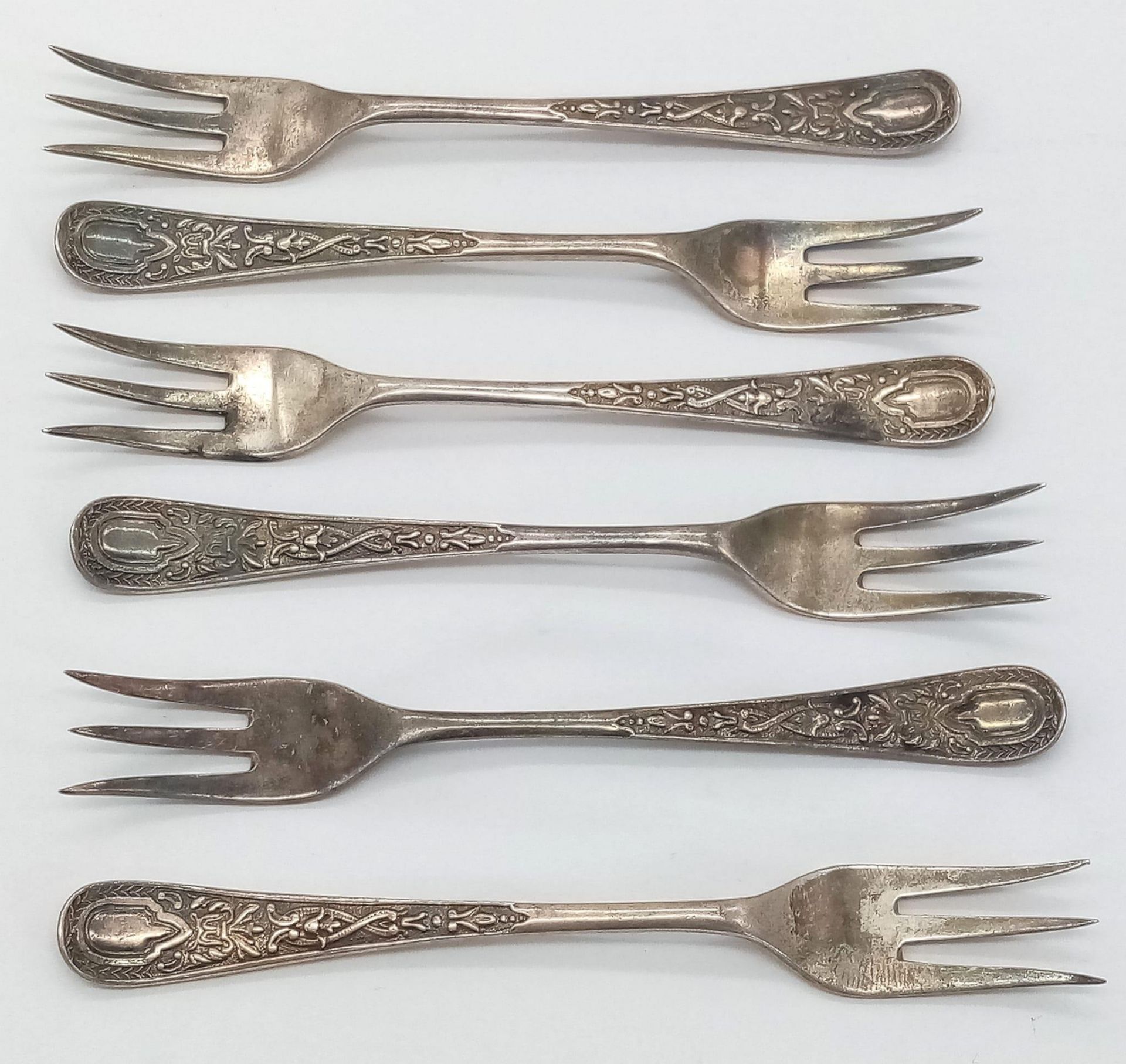 A set of 6 Antique sterling silver dessert forks with nicely ornate decoration on the body. Full