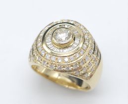 An 18K Yellow Gold and Diamond Bullseye Dress Ring. A central brilliant round cut diamond surrounded