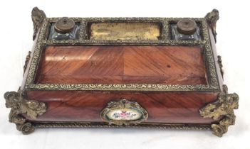 An Antique French Wood and Enamel Inkwell with Brass Ink Bottle holders and Ornate Brass Corners.