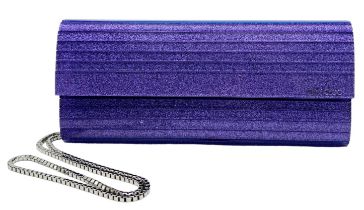 The Jimmy Choo Sweetie Clutch in a luxurious shade of purple is a stylish accessory measuring 25cm
