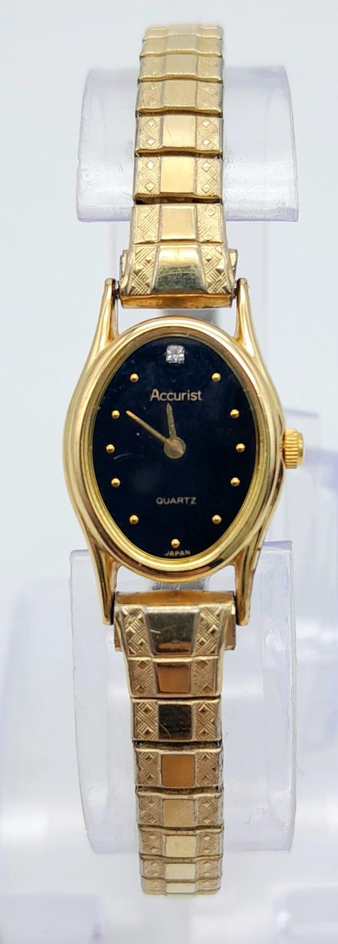 A Vintage Accurist Quartz Ladies Gold Tone Watch. Stainless steel strap and case - 10mm. Black dial.