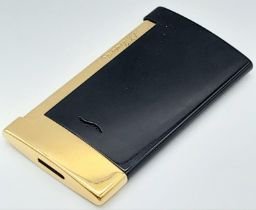 An ST Dupont Slim 7 Space Thin Lighter. This black and gilded chrome lighter weighs only 44g. It