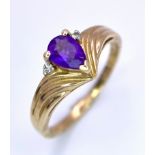 A Vintage 9K Yellow Gold Amethyst and Diamond Ring. Small teardrop amethyst with diamond accents.