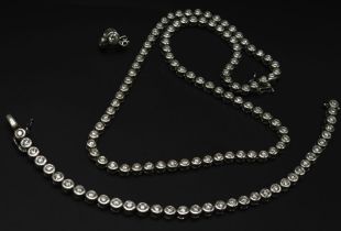 An Absolutely Stunning 18K White Gold and Diamond Tennis Necklace, Bracelet and Earring Set. 7ctw of