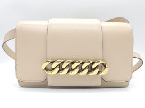 A Givenchy Nude Infinity Crossbody Bag. Leather exterior with front flap, gold toned hardware,