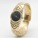 A Bulgari Parentesi 18K Gold Ladies Watch. 18k gold decorative torque bracelet. 18k gold circular