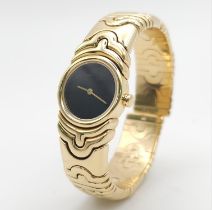 A Bulgari Parentesi 18K Gold Ladies Watch. 18k gold decorative torque bracelet. 18k gold circular