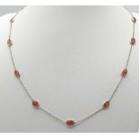 A STERLING SILVER NECKLACE SET WITH 13 OVAL CUT RUBIES. 48cm length, 4.1g total weight.