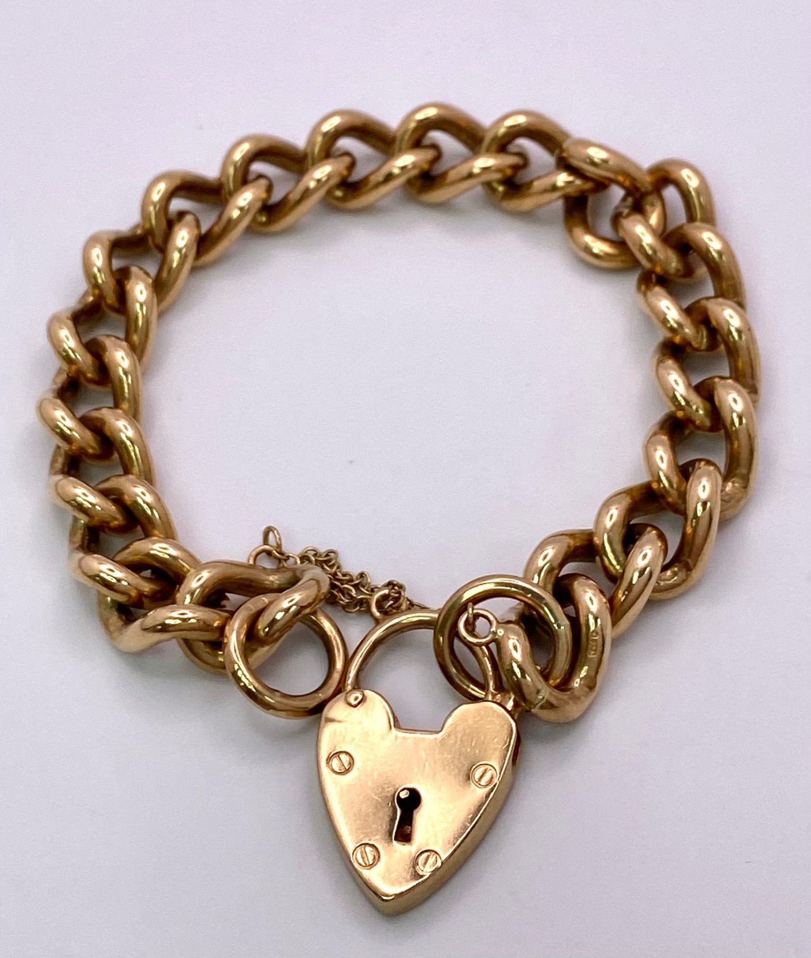 A Vintage 9K Yellow Gold Chunky Curb Link Bracelet with a Heart Clasp. 58g total weight. 17cm.
