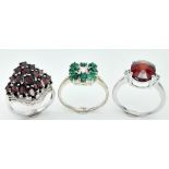 Three 925 Silver Gemstone Rings: Garnet - O, Red Stone - S and Emerald - S. 12.75g total weight.