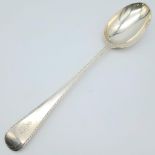 A SOLID SILVER SERVING SPOON MADE IN LONDON AND DATED 1925 . 122 3gms 28cms in length