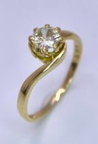 An 18K Yellow Gold Diamond Crossover Ring. Brilliant round cut diamond, slight tint - 0.40ct. Size