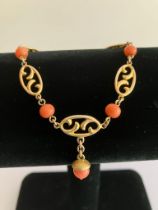 Beautiful 10 carat GOLD BRACELET Having oval scroll links and set with CORAL detail. Complete with