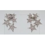 18kt White Gold, Diamond encrusted Star Earrings. Five stars per earring, each star paved with