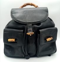 The Gucci Vintage Bamboo Leather Backpack in sleek black leather exudes timeless elegance. With a