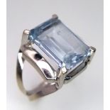 An 18K White Gold Aquamarine Ring. Rectangular step cut on a raised setting. Size O. 5.35g total