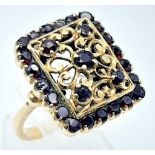 A showstopper, 18KT Yellow Gold, Garnet Set Ring. A stunningly unique, gold & stone interlacing
