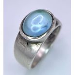 A 925 Silver Ring, with central blue stone. Size: N Weight: 5.22g