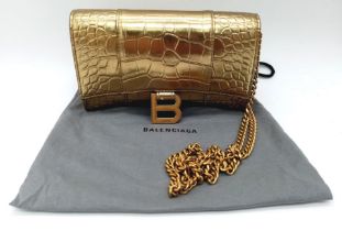 Introducing the Balenciaga Hourglass Bag in a stunning gold hue – a true embodiment of luxury and