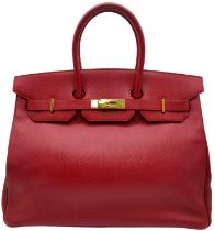 A Red Hermes Togo Birkin Bag. Considered the epitome of handbags, this classic Hermes Birkin is