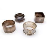 A collection of 4 Antique sterling silver napkin holders with different designs. Full Birmingham