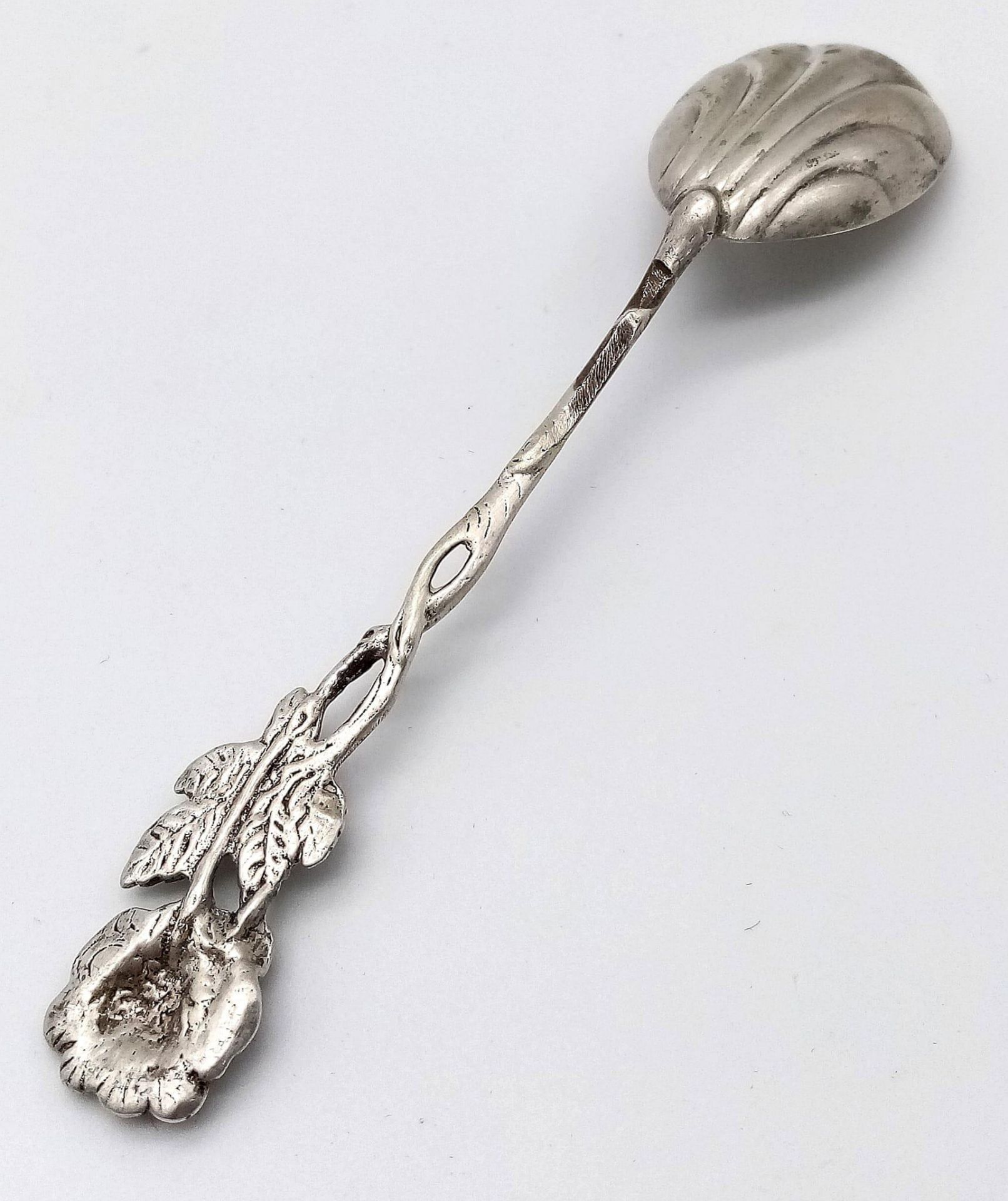 An antique silver spoon. A rose designed handle which flows down to a clam-shell like spoon bowl. - Image 4 of 4