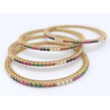 Set of 4, colourful gem set bangles. Bright gold tones and multi-coloured gems measuring 6cm in